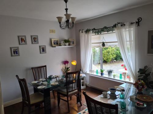 jadalnia ze stołem i krzesłami oraz oknem w obiekcie Coreen Guest House w mieście Tullamore