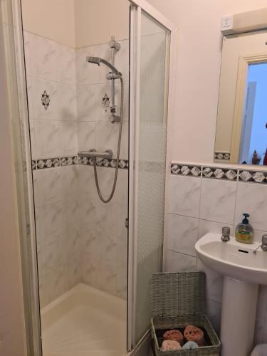 a bathroom with a shower and a sink at Coreen Guest House in Tullamore