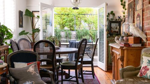 a dining room with a table and chairs at Newman House in Daylesford