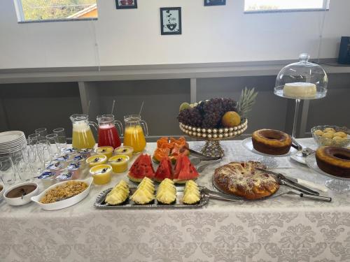 a table with a bunch of different types of food at Pousada Dona Tereza in Guapé
