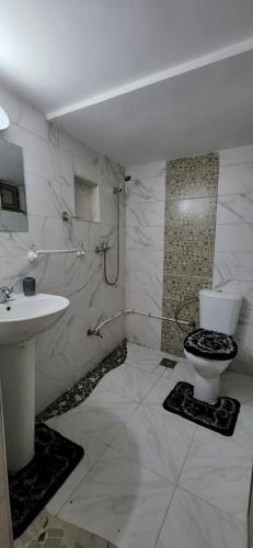 uma casa de banho branca com um WC e um lavatório em @MountainHouse : cozy and spacious duplex em Midelt