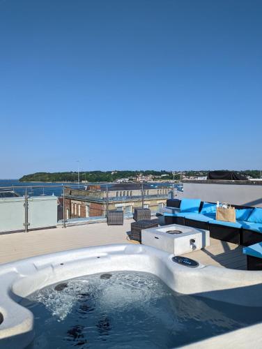 a hot tub on the roof of a building at Seafarer's View - 6 bedroom townhouse in Cowes, parking & seaviews. in Cowes