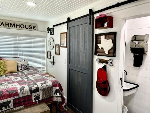 a bedroom with a bed and a barn door at Pet Friendly Graham 2 Bedroom Home Christmas 365 at The Mistletoe Farm in Graham