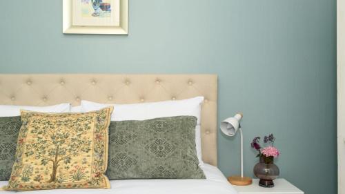 a bedroom with a bed with a pillow and a lamp at Casa Merenda Daylesford in Daylesford