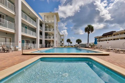 a swimming pool in front of a building at Coastal Waters 110 - 1 Bedroom, 1st Floor Pool Side Condo in New Smyrna Beach
