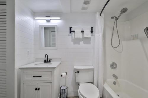 a bathroom with a toilet and a sink and a shower at 1 Bedroom -1 Bath Ocean View Condo At Ocean Trillium 802 in New Smyrna Beach