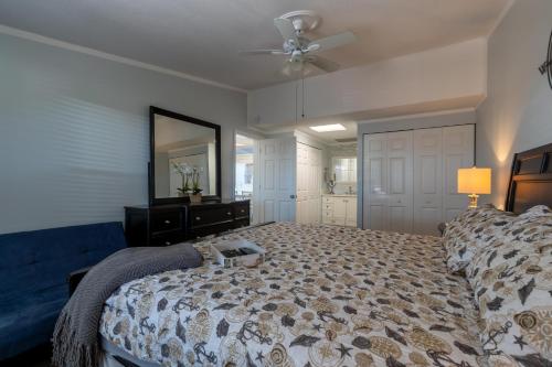 a bedroom with a bed and a ceiling fan at Dolphin Cove Cottage -22 & Pet Friendly! in New Smyrna Beach