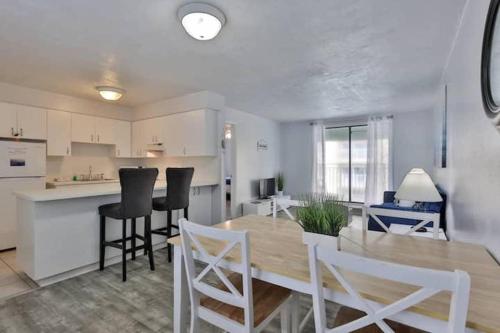 a kitchen and dining room with a table and chairs at Coastal Waters 210 - 2nd Floor 1 Bedroom With 2 Queen Beds in New Smyrna Beach