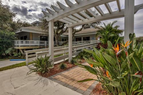 a white pergola in front of a house at Sea Woods 3 Bedroom 2 Bath in New Smyrna Beach