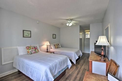 a bedroom with two beds and a table with a lamp at Coastal Waters 108-109- 2 Bedroom 2 Bath Pool Side Condo! in New Smyrna Beach