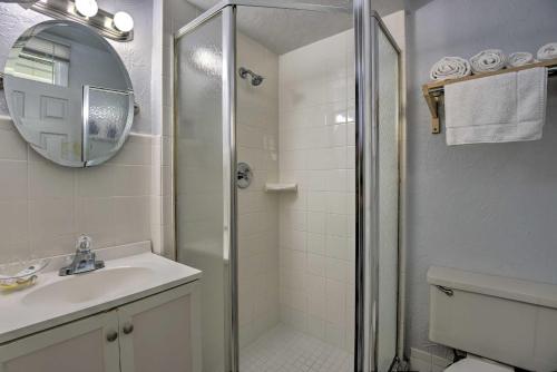 a bathroom with a shower and a sink and a mirror at Coastal Waters 108-109- 2 Bedroom 2 Bath Pool Side Condo! in New Smyrna Beach