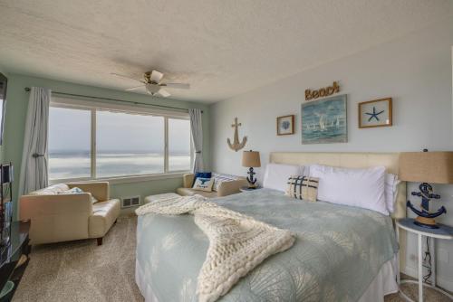 a bedroom with a bed and a large window at Prime Coastal Retreat on Lincoln City Beach! in Lincoln City
