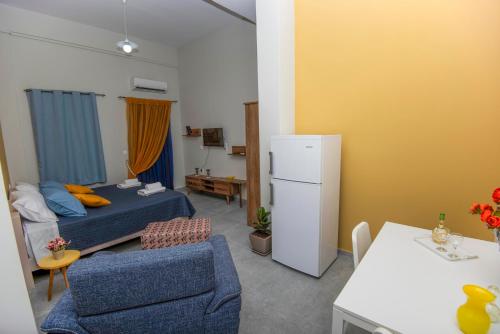 a small room with a bed and a refrigerator at Lithos apartments in Kalymnos