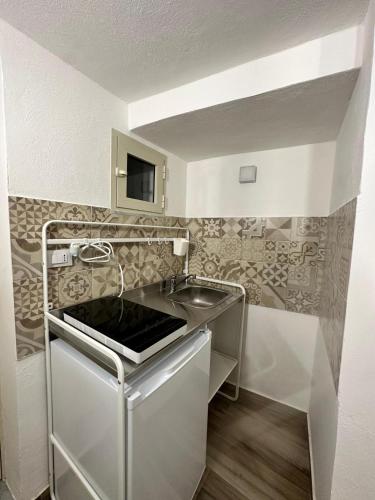 a small kitchen with a sink and a microwave at Agathae Home in Catania