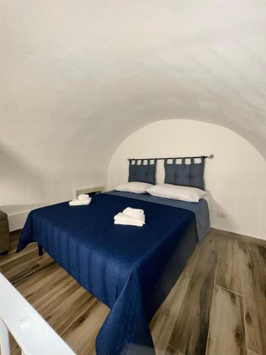 a bedroom with a blue bed with towels on it at Agathae Home in Catania