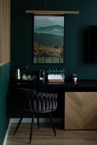 a dark room with a table and a chair at Willa Sudety in Kudowa-Zdrój