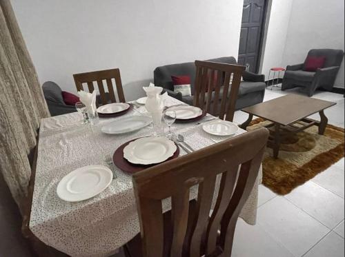 a table with plates and wine glasses on it at CASA in Cape Coast