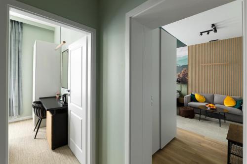 a hallway leading to a living room with a couch at Willa Sudety in Kudowa-Zdrój