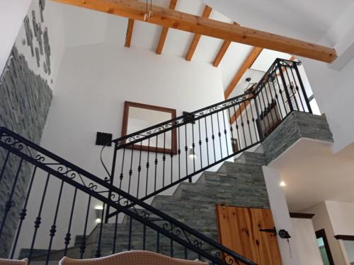a staircase with black railings and stone stairs in a house at Lavender Hill Hvar Villa - pool, jacuzzi,sauna,BBQ in Stari Grad