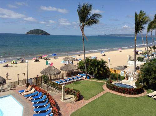 a view of the beach from a resort at Cabañas del Capitan in Rincon de Guayabitos