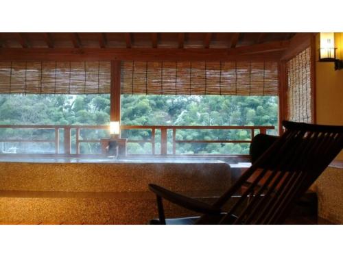 a room with a chair and a window with a view at Yumura Onsen Tomiya - Vacation STAY 81727v in Yumura