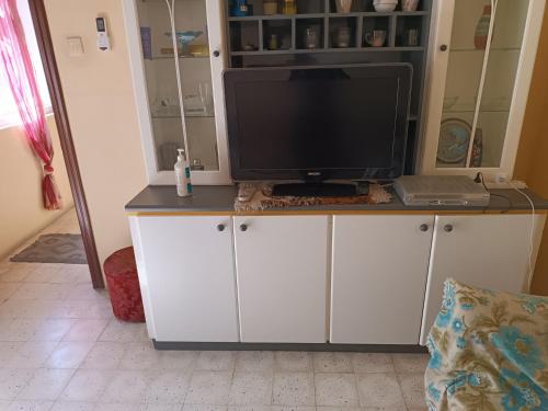 a tv sitting on top of a white cabinet at House of character that Quest will like . in Ħal Balzan