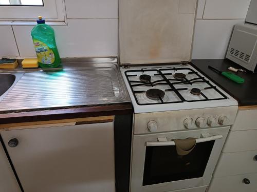 a small kitchen with a stove and a sink at House of character that Quest will like . in Ħal Balzan