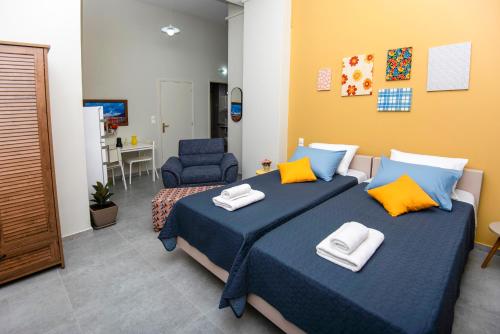 a bedroom with two beds with towels on them at Lithos apartments in Kalymnos