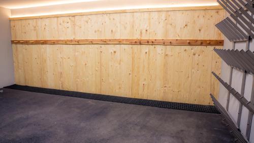 a garage with wooden panels on the wall at Appartement- und Wellnesshotel Charlotte - 3 Sterne Superior in Seefeld in Tirol
