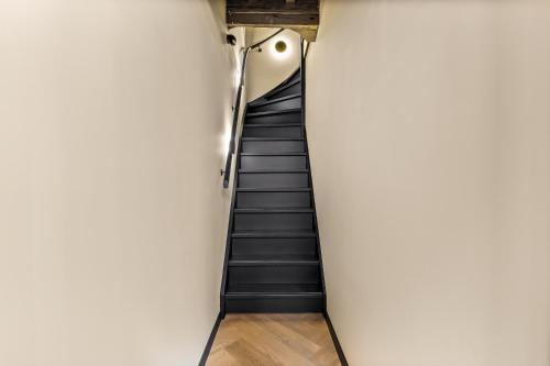 a staircase in a building with black stairs at In Den Gouden Beer in Vlissingen
