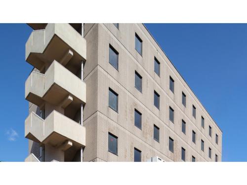 a tall building with windows on the side of it at Matto Terminal Hotel - Vacation STAY 98884v in Hakusan