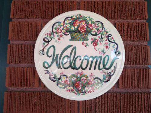 a plate with the word welcome on a wall at The Charin Inn in Clearfield