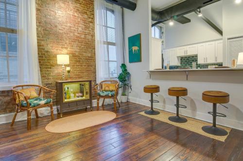 a living room with two chairs and a fireplace at Historic Memphis Condo Walk to Beale Street! in Memphis