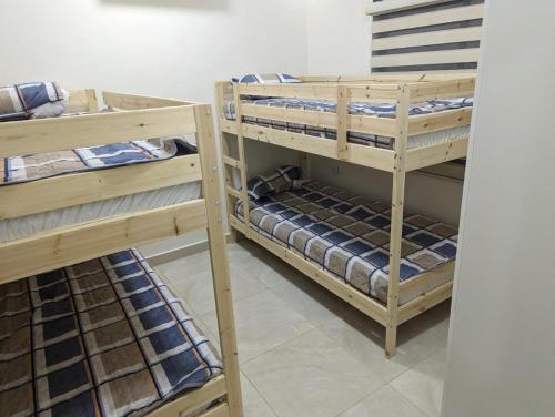 two sets of bunk beds in a room at Siwar Al-Thahab Suites & Hotel Apartments in Aqaba