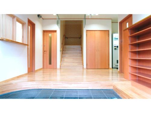 an empty room with a hallway with wooden floors at Business Ryokan Fukuzumi - Vacation STAY 01039v in Shizuoka