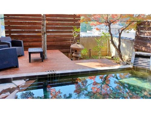 a swimming pool with a table and a bench on a deck at Shunjuan Kikusui - Vacation STAY 03162v in Chikuma