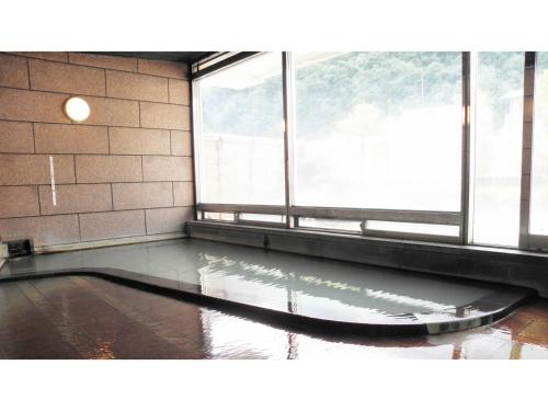 an empty room with a large window and water on the floor at Shunjuan Kikusui - Vacation STAY 03162v in Chikuma