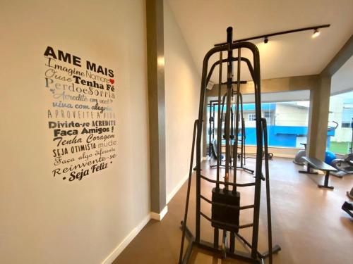 a gym with a sign on the wall and a ladder at Navega Beach Palace Hotel in Navegantes