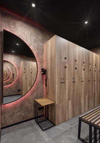 a locker room with wooden lockers and a mirror at Apartel Uzhhorod in Uzhhorod