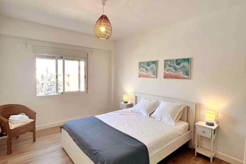 een slaapkamer met een bed, een stoel en een raam bij Apartamento en el puerto in Denia