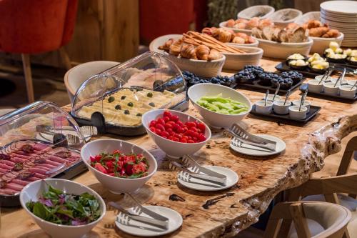 a table topped with bowls of food and other foods at Apartel Uzhhorod in Uzhhorod