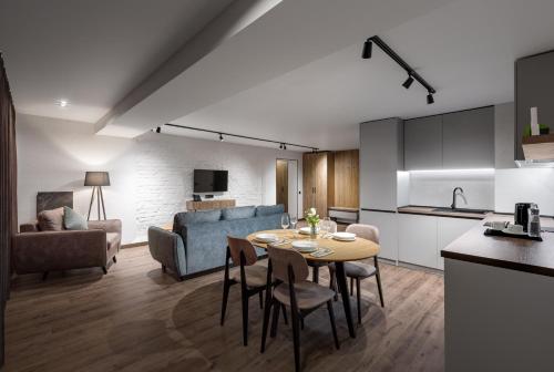 a kitchen and a living room with a table and chairs at Apartel Uzhhorod in Uzhhorod