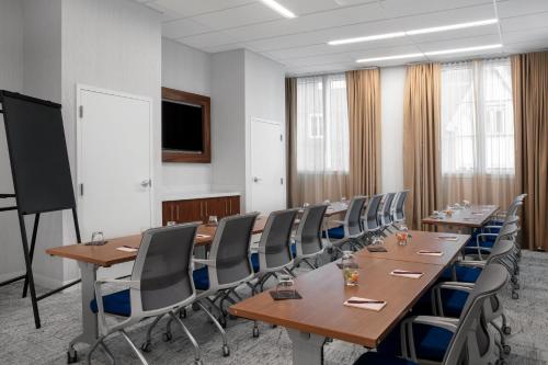 a conference room with long tables and chairs at Residence Inn by Marriott Norwalk in Norwalk