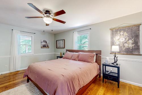 a bedroom with a bed and a ceiling fan at The Haggai House in Demorest