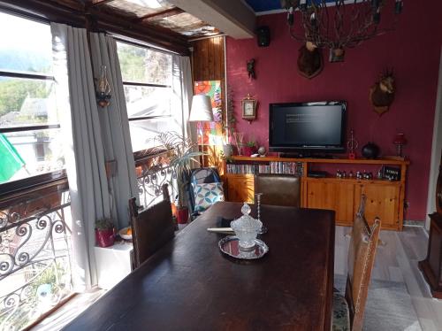 a dining room with a table and a television at Remig Ranch in Challand Saint Victor
