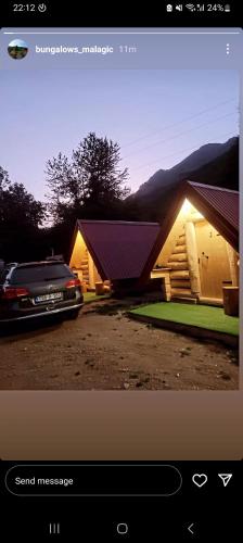 a car parked in front of a small house at Bungalows Malagić in Gusinje