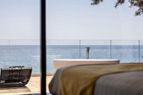 a room with a table and a view of the ocean at Baba Residences in Alassio