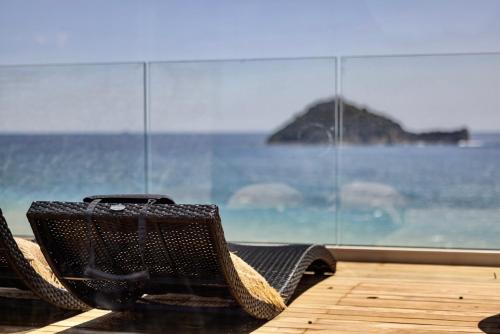 a suitcase sitting on a chair in front of a window at Baba Residences in Alassio