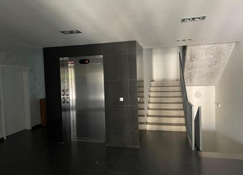 a hallway with a elevator and stairs in a building at Bratislava FORESTPARK, FREE parking, self-check IN in Bratislava