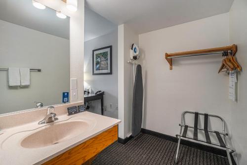 a bathroom with a sink and a mirror at Travelodge by Wyndham Traverse City MI in Traverse City